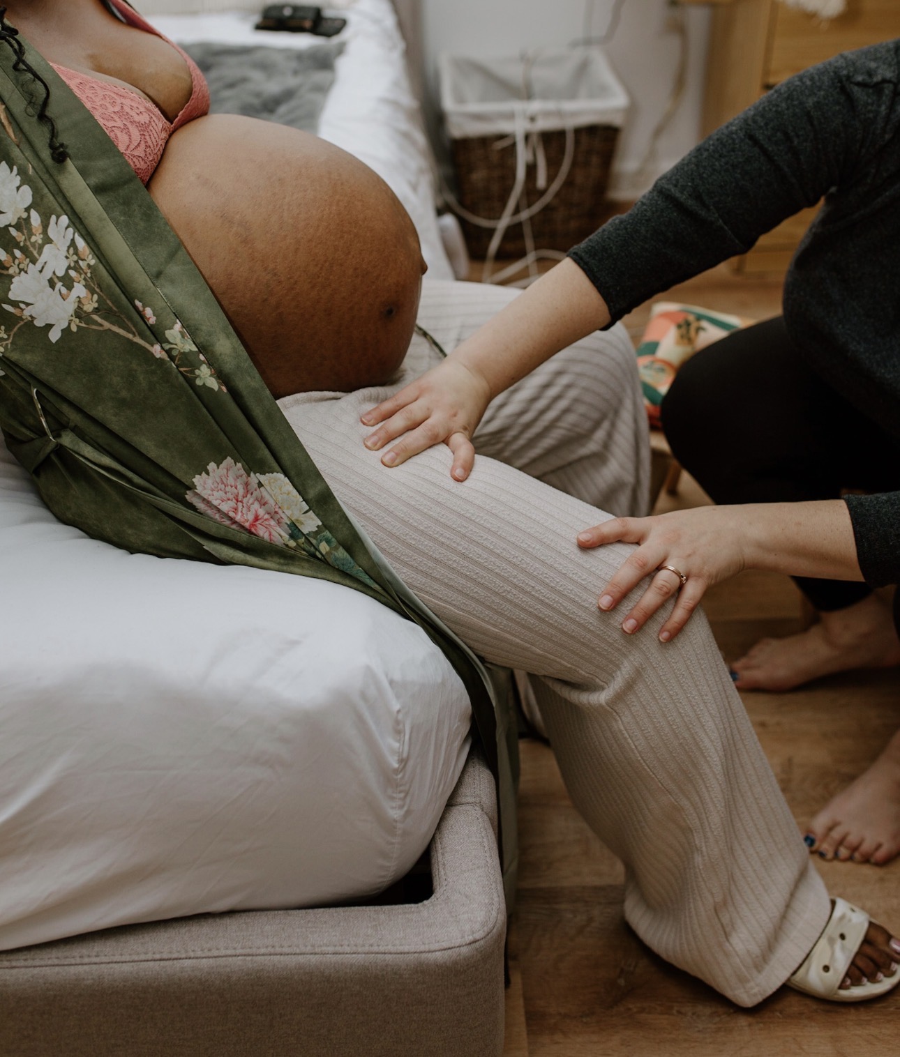 A midwife's gentle hands supporting Precious during labor